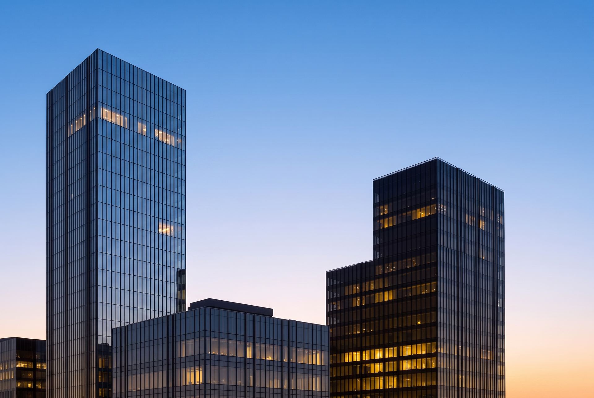 Class A commercial office towers at dusk